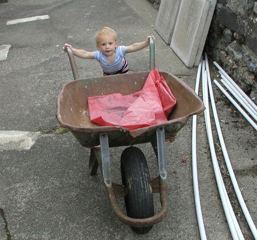 Child pushing wheelbarrow