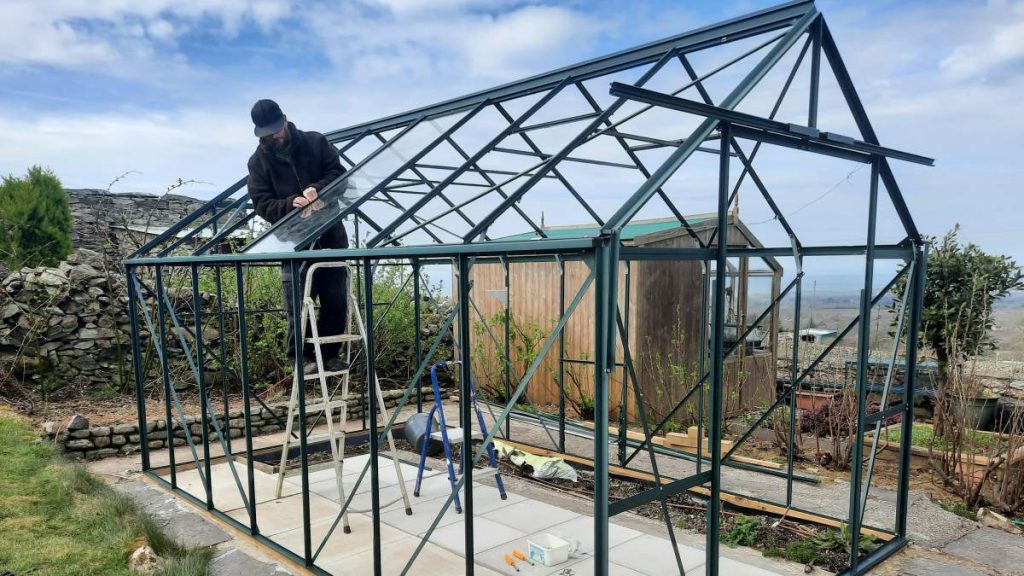 Man Glazing a Greenhouse
